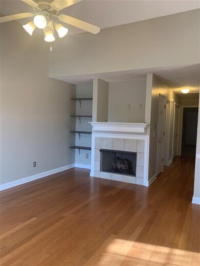 Features hard wood flooring, cozy fireplace and op