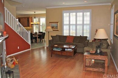 Large living room with wood style flooring and pla