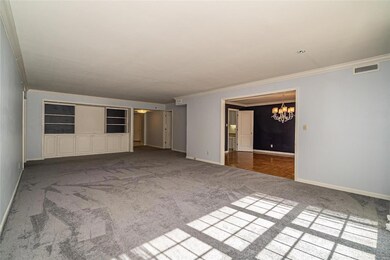 Spacious living room with built in cabinets, opens