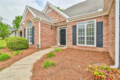 Doorway to property featuring brick siding and roo