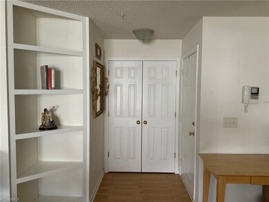Front entrance with coat closet and built in shelves