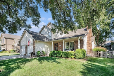 Traditional-style home featuring brick siding, a porch, and roof with shingles