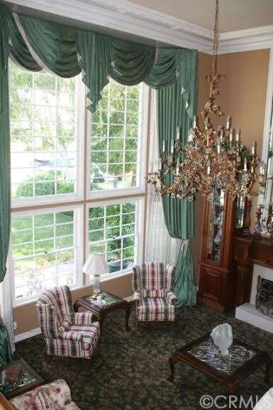 Formal living room with custom draperies, upgraded