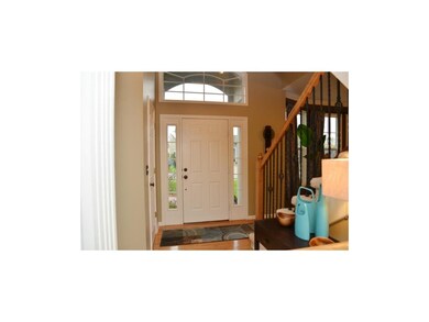 Spacious, two-story entry, with wrought iron spind