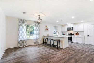 Eat-in kitchen with bar seating on large kitchen i