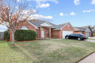 Single story home with a front lawn and a garage
