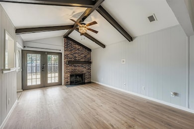 Unfurnished living room with a brick fireplace, l