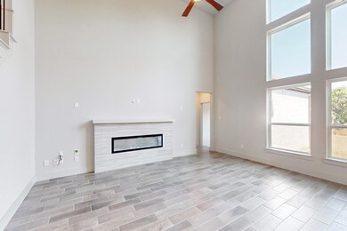 Unfurnished living room with a tiled fireplace, ce