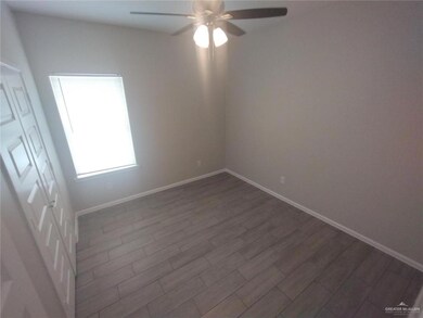 Spare room with a ceiling fan and dark wood-style flooring