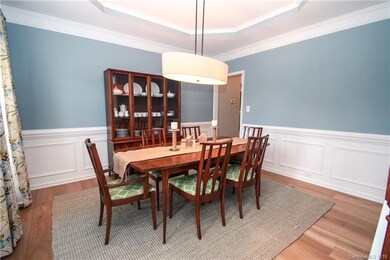 Formal dining room with a recessed ceiling.