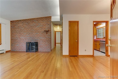 Unfurnished living room featuring wood finished fl