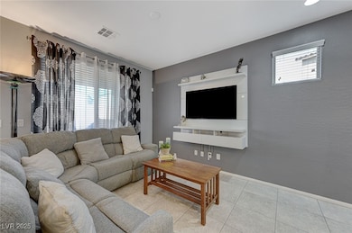 Living area featuring light tile patterned floors,