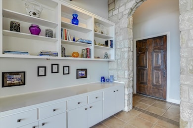An entry foyer opens to the living, dining and kitchen.