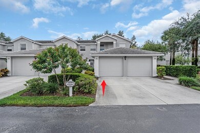Traditional-style house with driveway, stucco siding, a tiled roof, and an attached garage