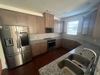 Kitchen featuring sink, dark hardwood / wood-style