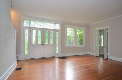 Living room with hardwood flooring, crown molding 