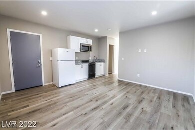 Kitchen featuring freestanding refrigerator, stain