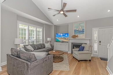 Living room featuring light hardwood / wood-style flooring, ceiling fan, and high vaulted ceiling