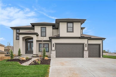Prairie-style house featuring stucco siding, concrete driveway, and roof with shingles