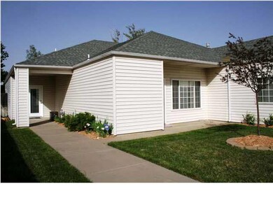 Front of the home with one of two outside patios. Enjoy a low maintenance life style with the HOA caring for the lawn maintenance around the home, snow removal, and common ground maintenance in the neighborhood.