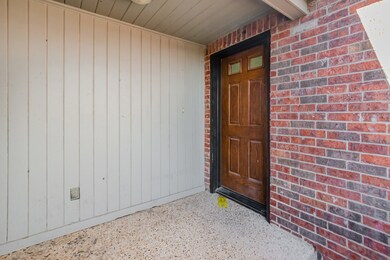 Entrance to property featuring brick siding