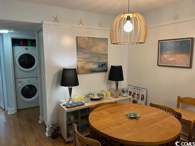 Dining area featuring stacked washer / drying mach