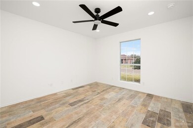 Spare room featuring ceiling fan and light wood-type flooring