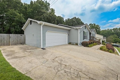 View of home's exterior with an attached garage and driveway