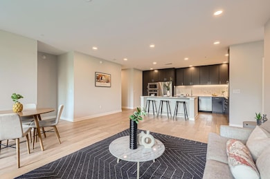 Living area with light wood finished floors, rece