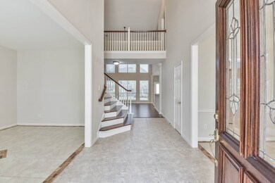 Two story entry with wrap around stairs make a statement