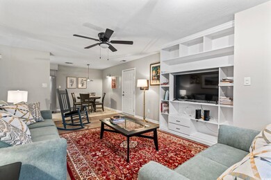 Living area featuring baseboards, a textured ceili