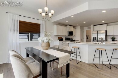 Dining area with light wood finished floors, reces