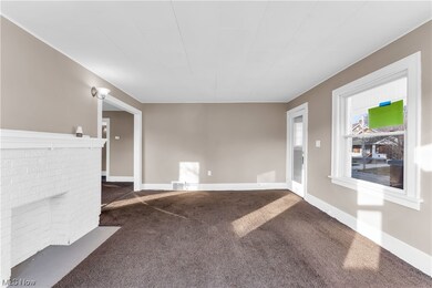 Unfurnished living room with dark colored carpet
