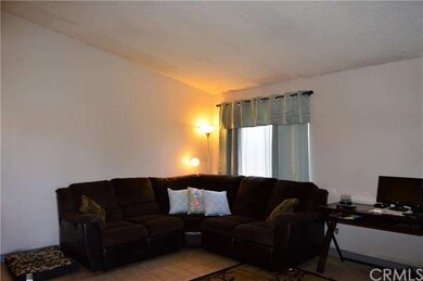 Spacious living room with vaulted ceilings, tile f