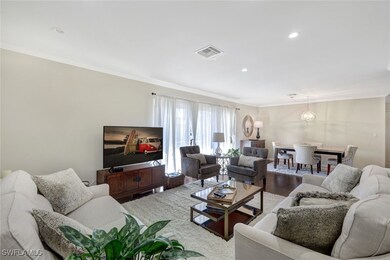 Living room with ornamental molding and hardwood /