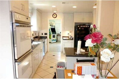 Tile floors throughout kitchen.  Light bright cabi