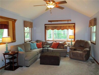 The large, light-filled great room features a bay 