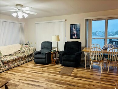 Living room with ceiling fan and wood finished flo