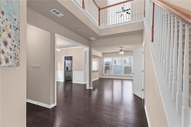 Foyer entrance featuring dark wood-style floors, c