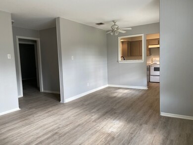 Open living space with light gray walls and wood-s