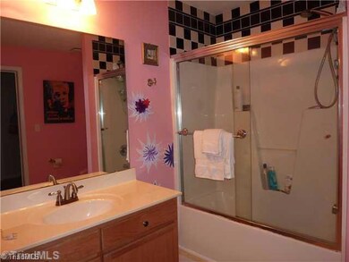 Bath. Bright and colorful bath is connected to walk-in closet/laundry area.