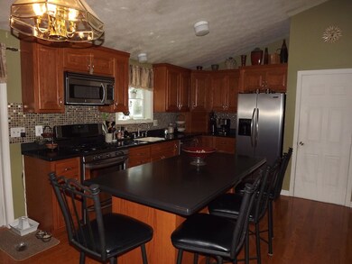Open concept kitchen with cathedral ceiling