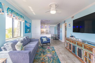Living area featuring ornamental molding, visible vents, ceiling fan, and light wood finished floors