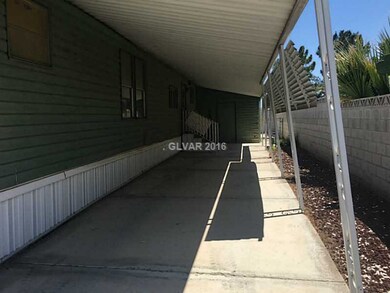 Property Photo. Back covered carport.