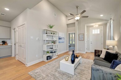 Living room with lofted ceiling, visible vents, l