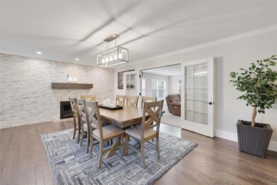 Dining Room, New hardwood floors, New tile surround and mantel Gas Fireplace. French Door Leading to Family Room.