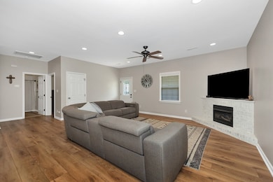 Living Room- Lvp flooring, ceiling fan, recessed lighting, gas log fireplace
