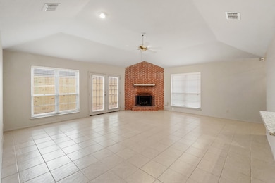 Gather your family and guests together in your huge family room! Featuring vaulted ceilings, brick fireplace fresh paint, ceramic tile floors, and large windows letting in tons of natural light!