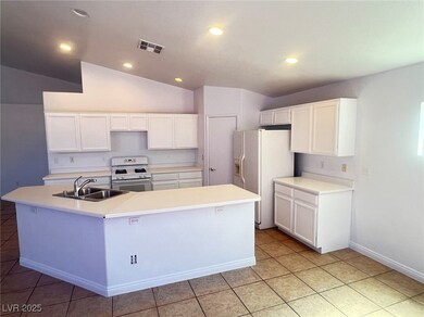 Kitchen with a sink, visible vents, white applianc