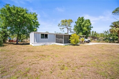 Back of house with a sunroom and a yard